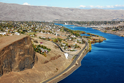 View from KiwiAir helicopter looking back at Swallows Nest Rock along the Snake River with Clarkston, Washington, and Lewiston, Idaho, in the background.